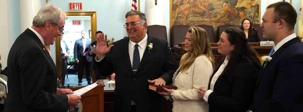 Commissioner Al Mirabella is sworn in by Governor Phil Murphy, with his family at his side