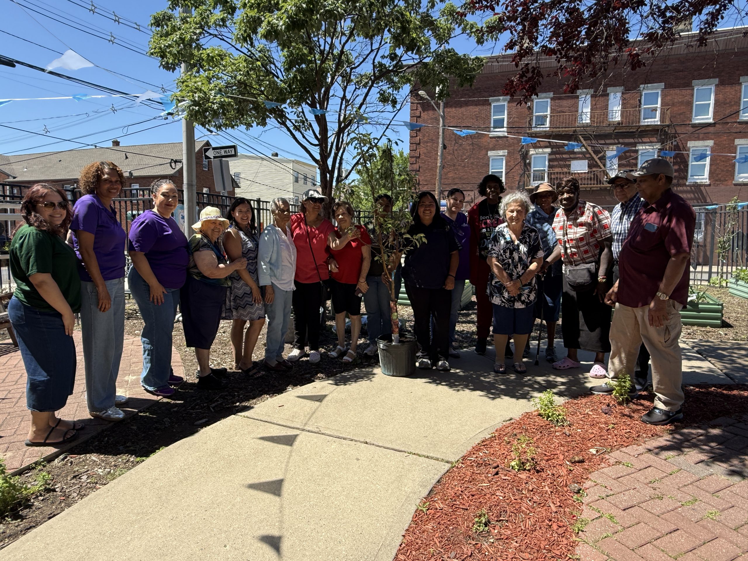 Prevention Links, Groundworks Elizabeth and Union County representatives pose and smile for the camera with Elizabethport Community Center members  