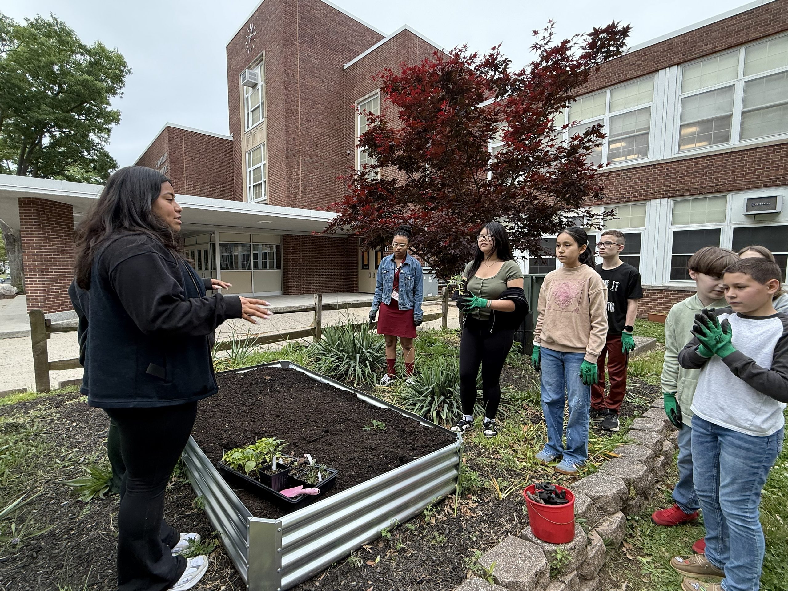 image of Ashley from Groundworks Elizabeth giving Kawameeh students a presentation on the plants they will be adding to their garden