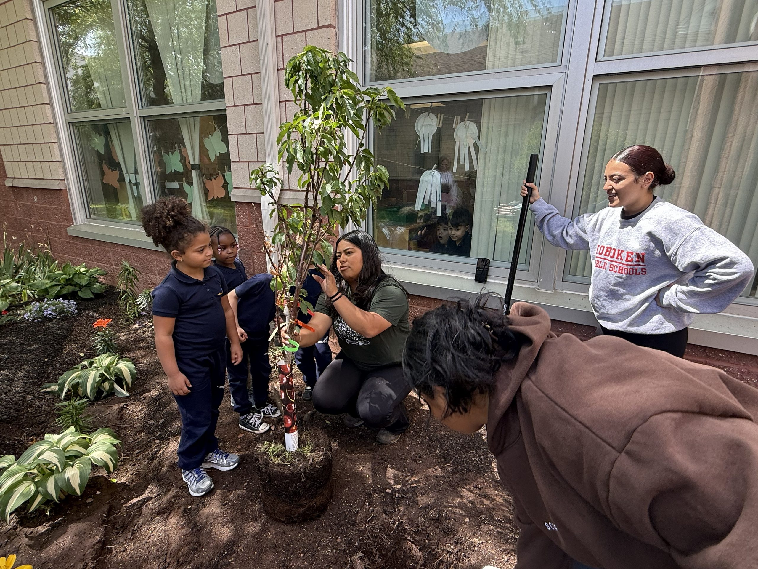 School No. 52 students and Groundwork Elizabeth staff planting a cherry tree