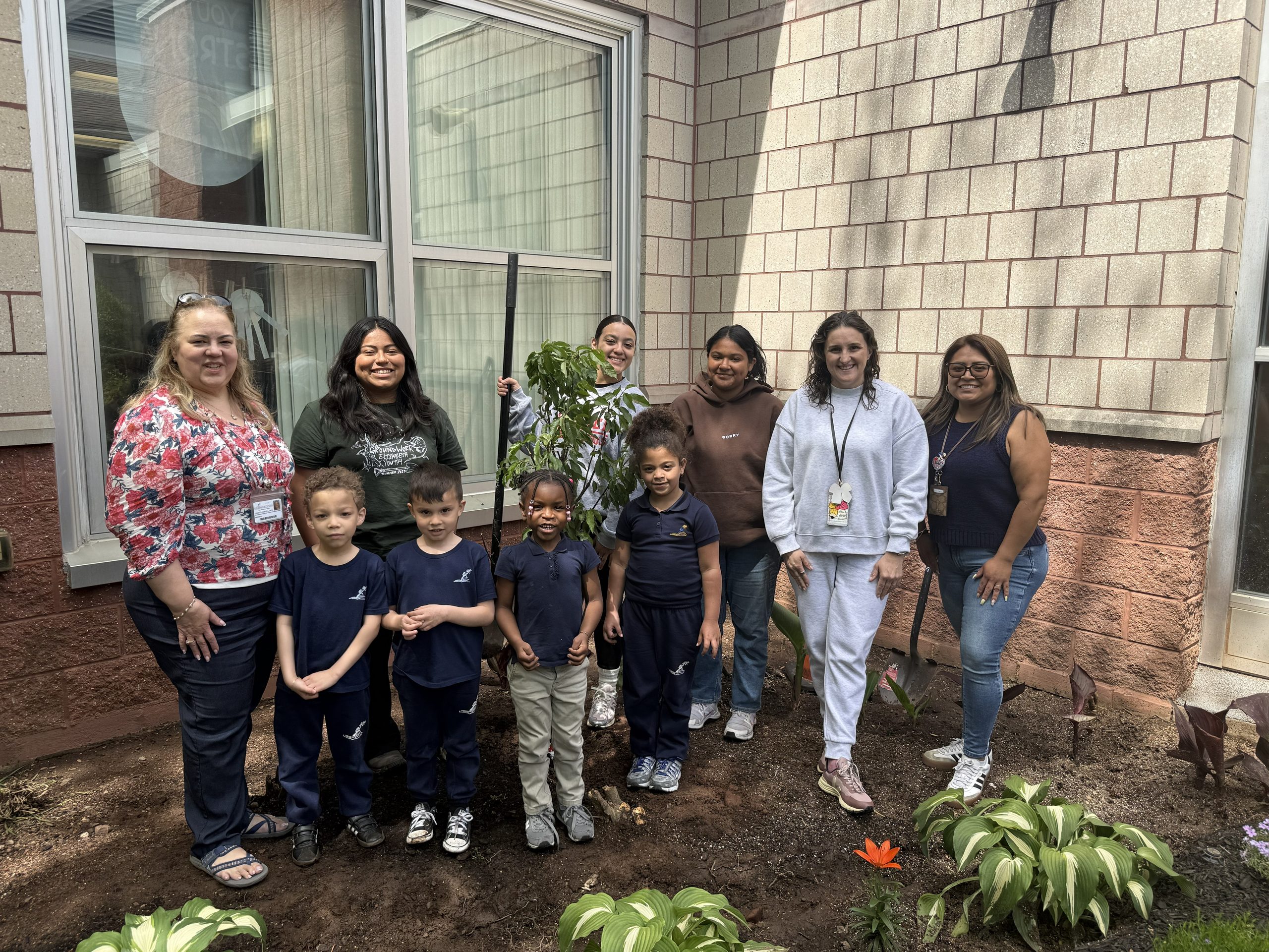 School No. 52 students, teachers, and Groundwork Elizabeth staff pose next to their newly planted cherry tree
