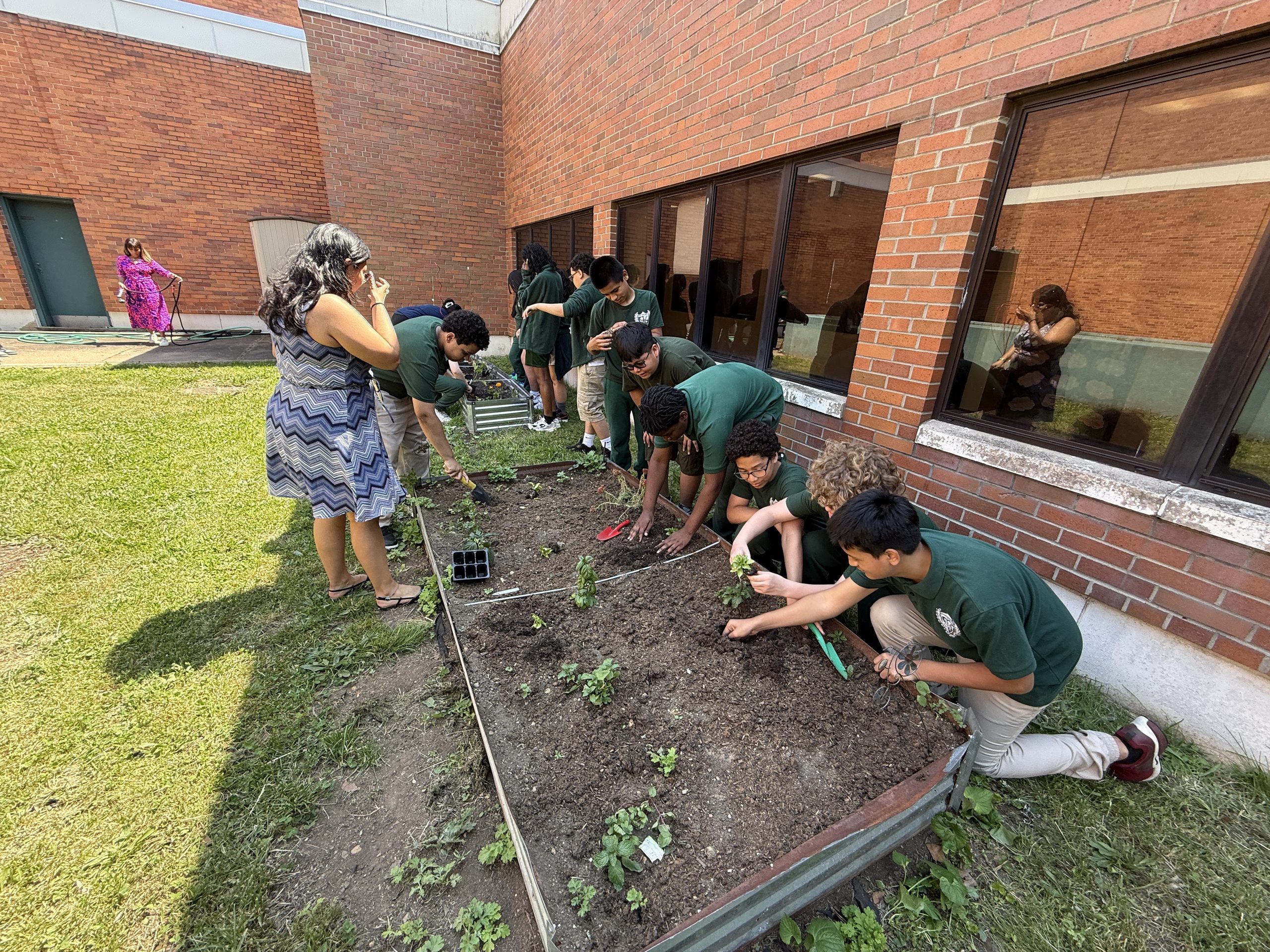 Jerome Dunn students and Groundwork Elizabeth team planting in raised garden beds