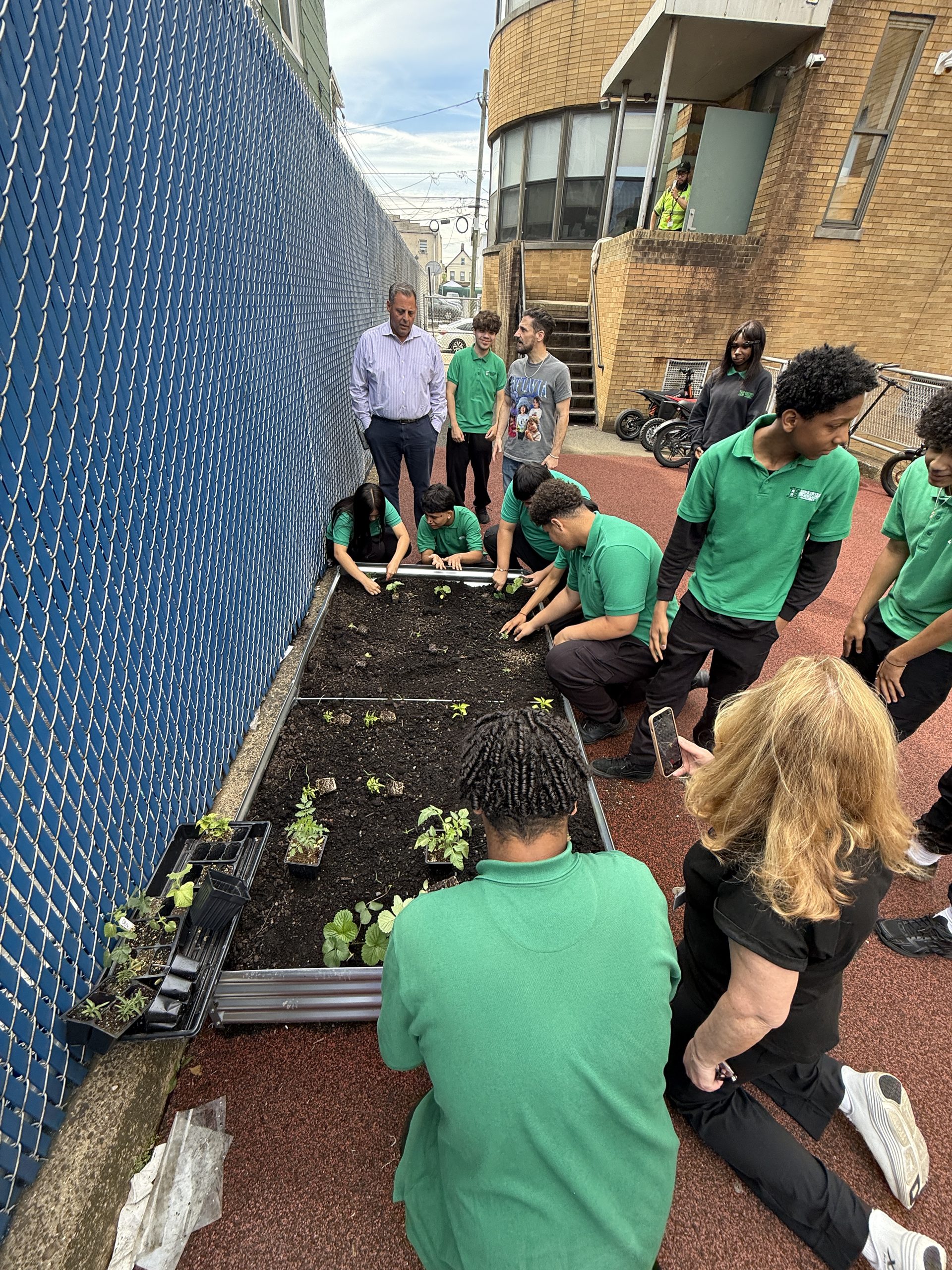 John E. Dwyer students planting in their raised garden bed 