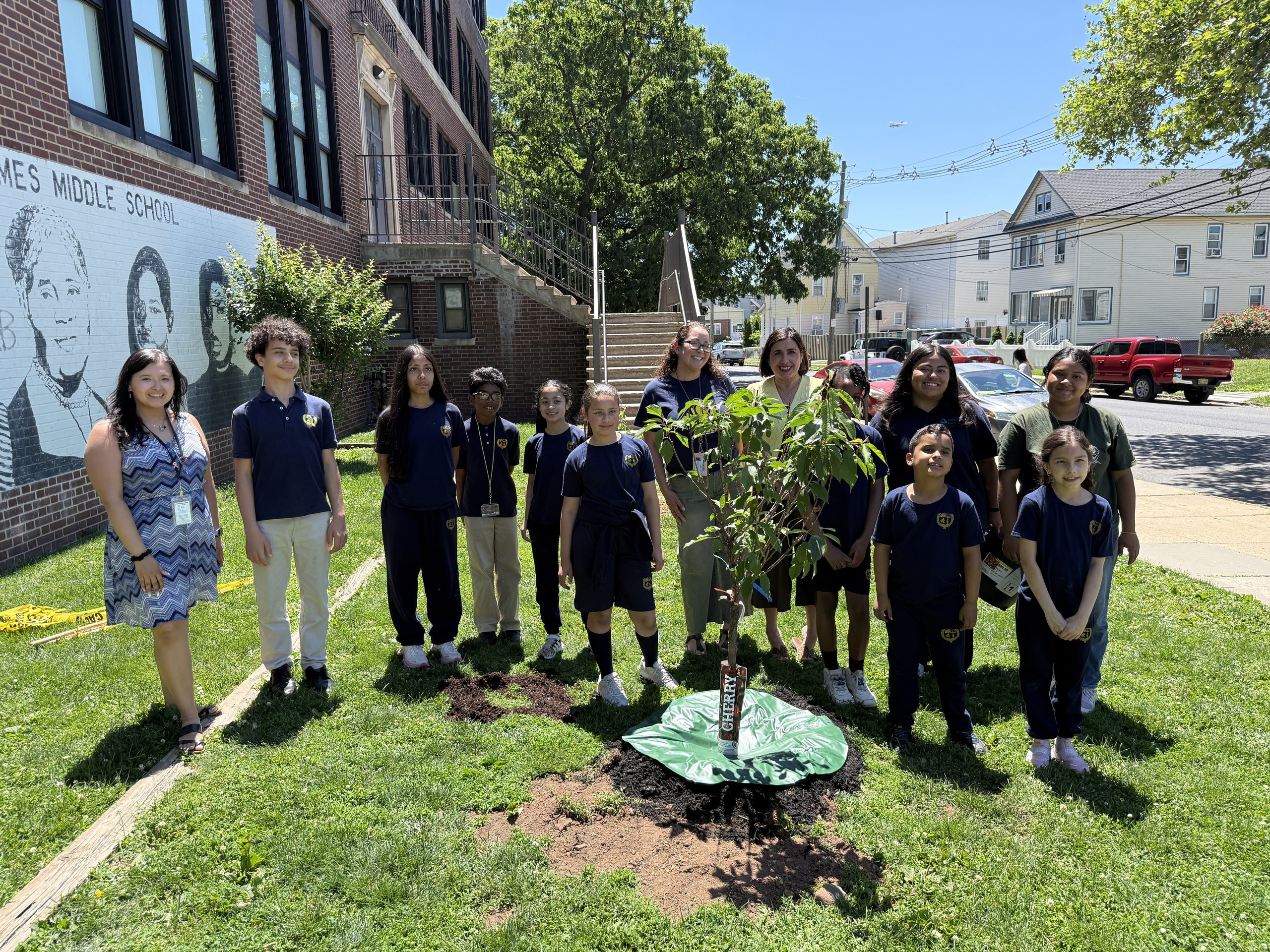 School No. 7 students, faculty, Groundworks Elizabeth staff and a Union County representative pose for a picture behind their newly planted cherry tree