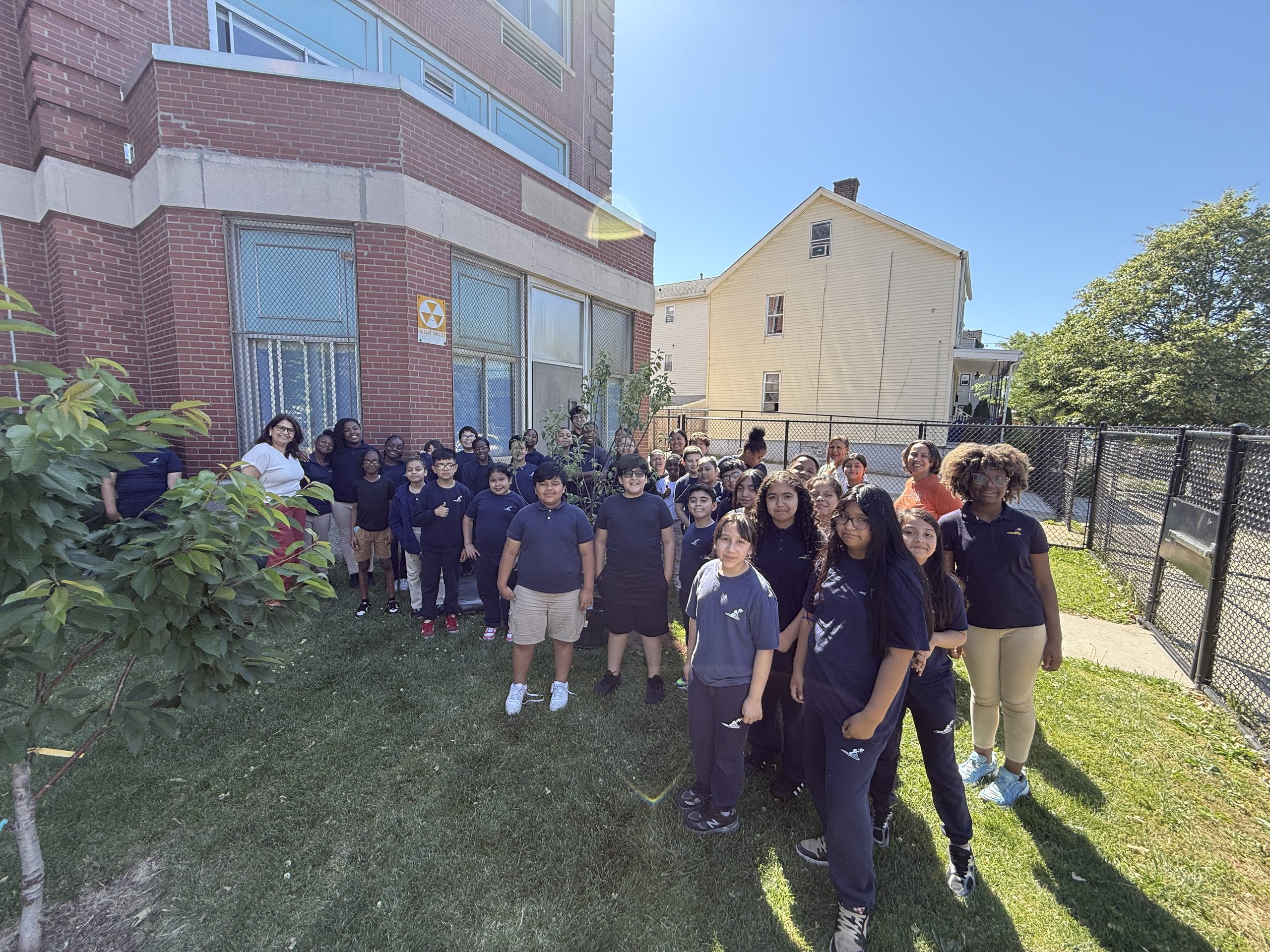 John Marshall School No. 20 students, faculty and Groundworks Elizabeth staff smile and pose for the camera in front of the school