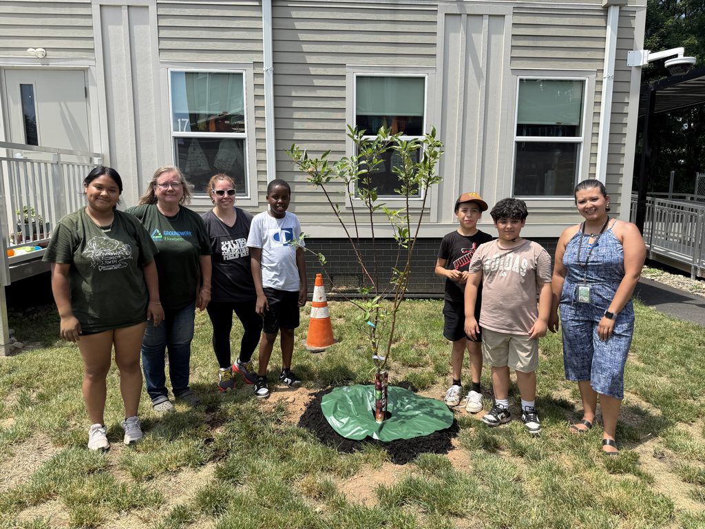Children planting an apple tree.