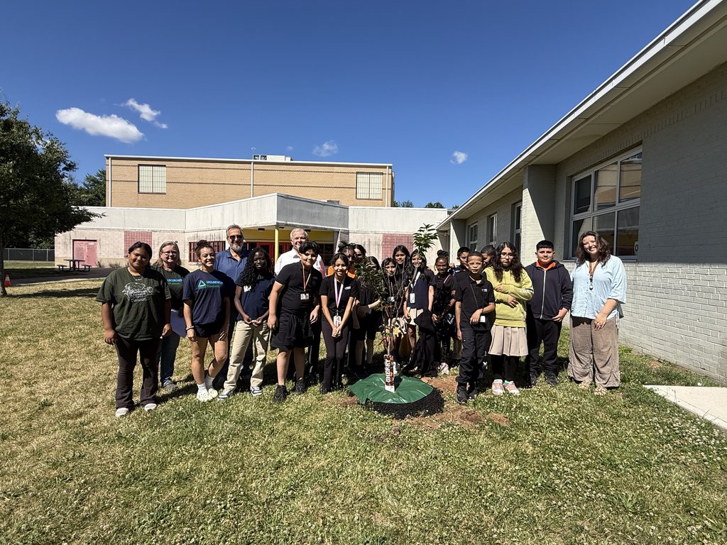Chairman Bodek and school members planting a tree.