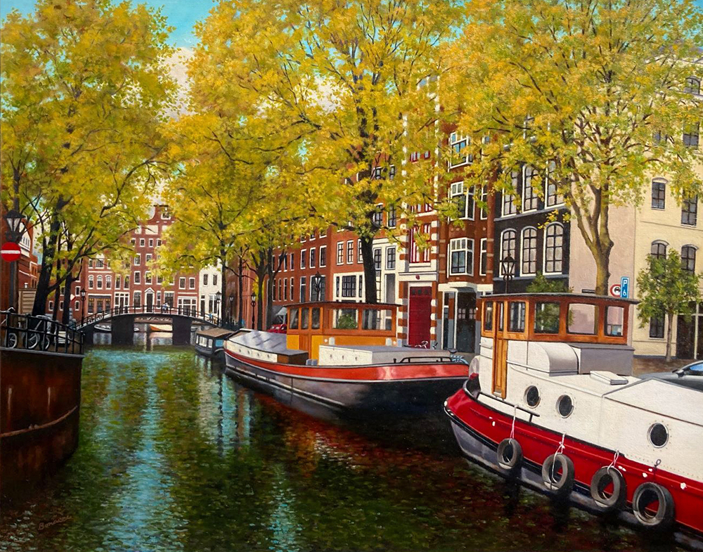 Eileen Bonacci was awarded First Place for Oil Painting by a Professional artist for this painting, titled “Afternoon in Amsterdam.” This work was also awarded Best of Show among all entries by a Professional Artist. This colorful painting depicts a picturesque Amsterdam canal scene on a sunny day. A canopy of leafy trees fills the entire top half of the painting. The yellowish-green color of the leaves indicates that it’s springtime. At the lower left, green-blue water in the canal reflects the blue sky in lovely shades of teal. Our vantage point as viewer might be from a bridge directly over the canal. The focal point is two handsome red-and-white canal boats in the lower right foreground. Beautiful, iconic row houses line the canal. This work is painted in a crisp, realistic style.