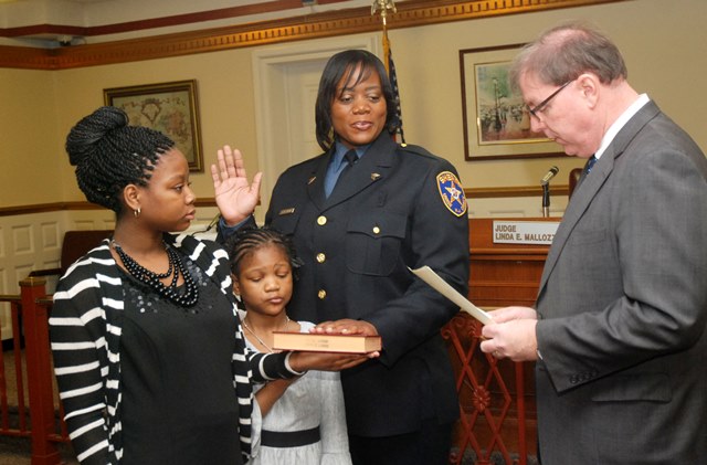 Veteran Sheriff’s Officer Nakera Sherman is sworn in to her new rank of Sergeant by Union County Sheriff Joe Cryan with the help of her daughters Kayla (far l.) and Jada. Photo: Jim Lowney/County of Union.