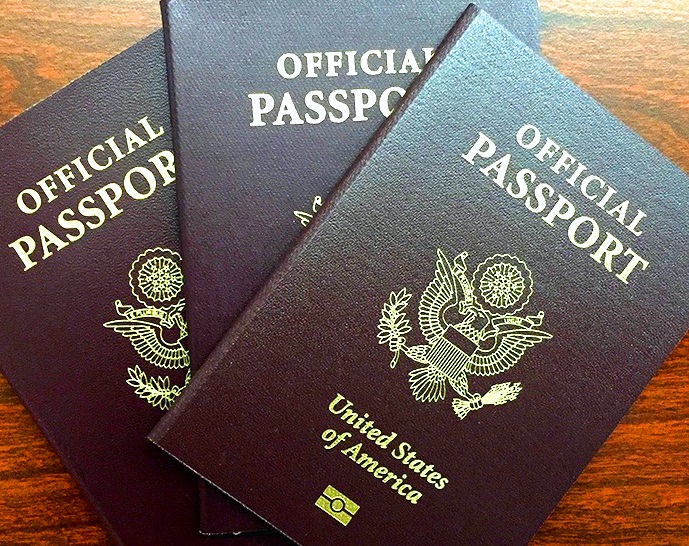 three passports stacked on top of each other