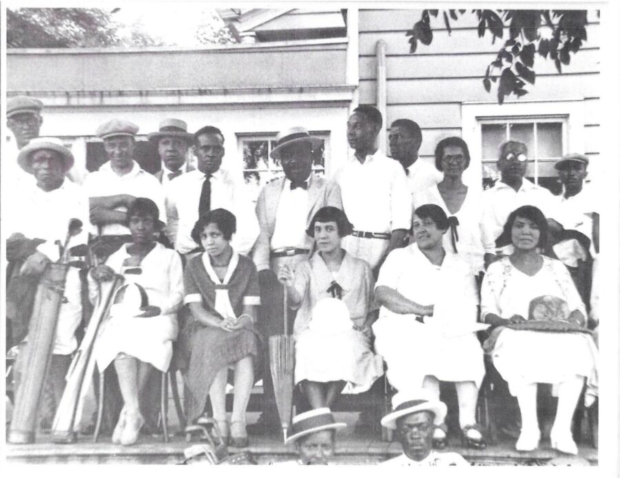 black and white photo of a group of people posed for the camera